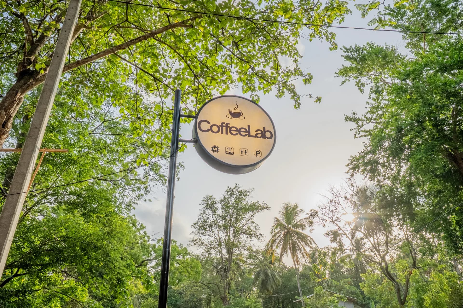 CoffeeLab Sigiriya café sign among the trees